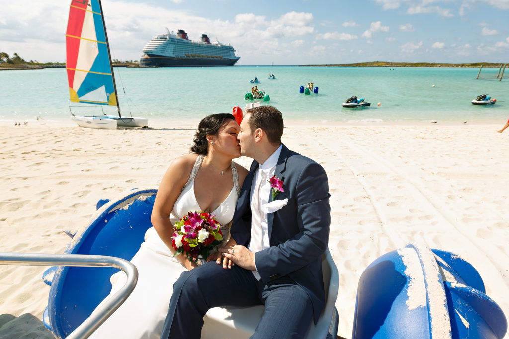 Bride and groom kissing with Disney dream in background
