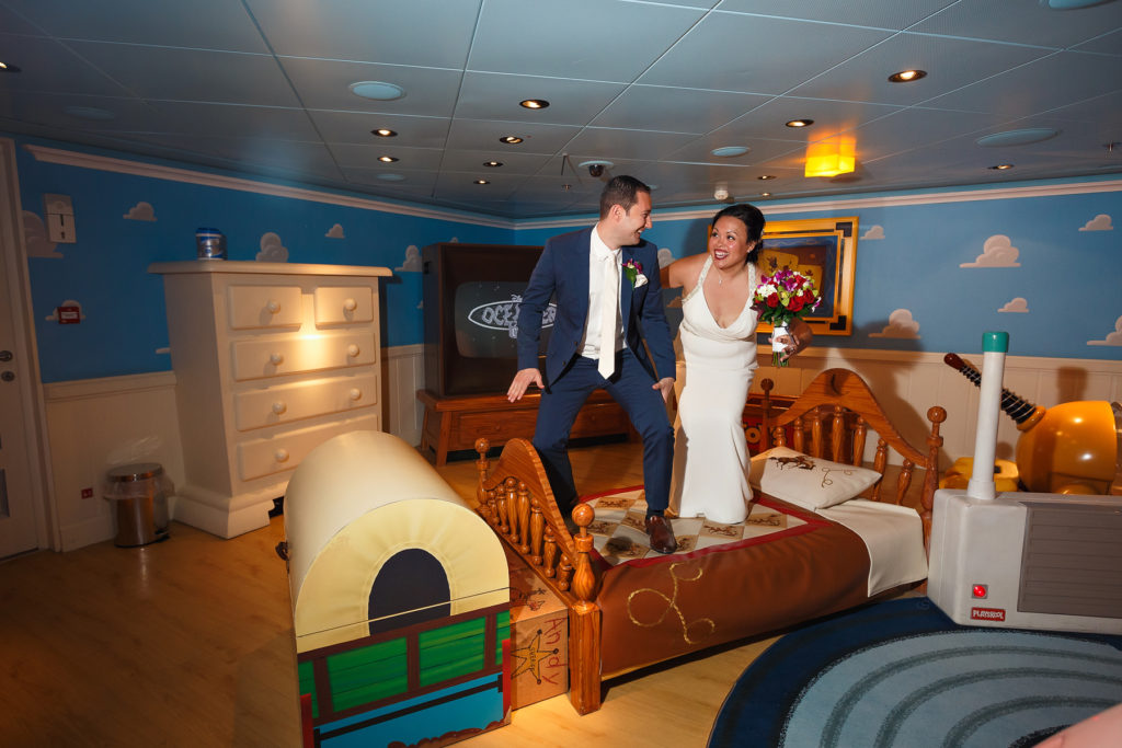 Disney bride and groom jumping on bed in Andy's room