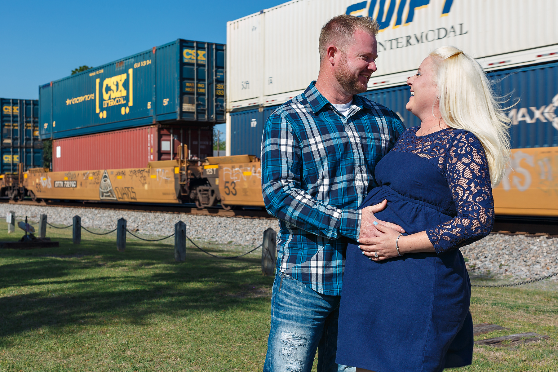 Pregnant Couple in front of train