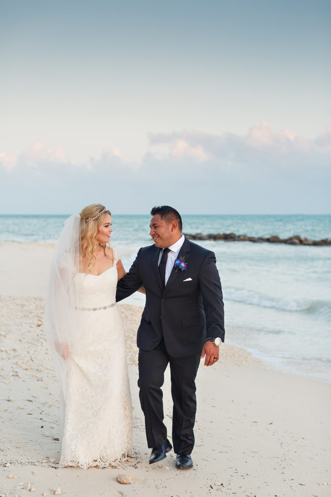 bride and groom walking on the beach fort zachary taylor state park wedding